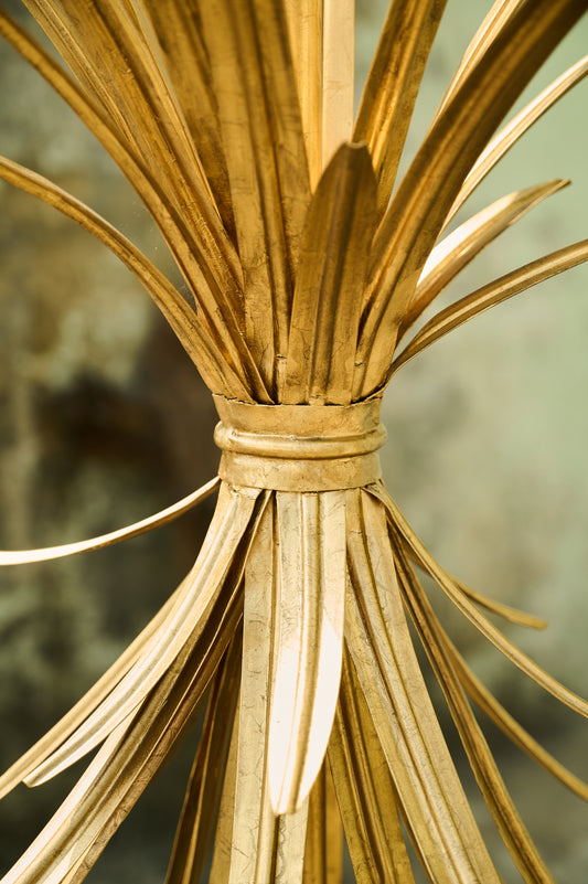 Close-up of a decorative gold lamp with a blurred background