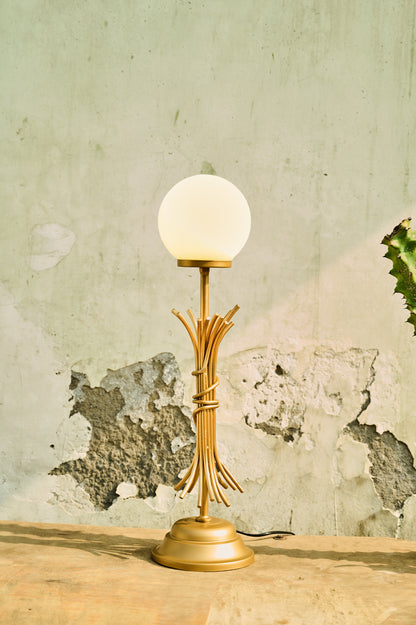 Vintage-style table lamp with a white bulb on a textured wall background