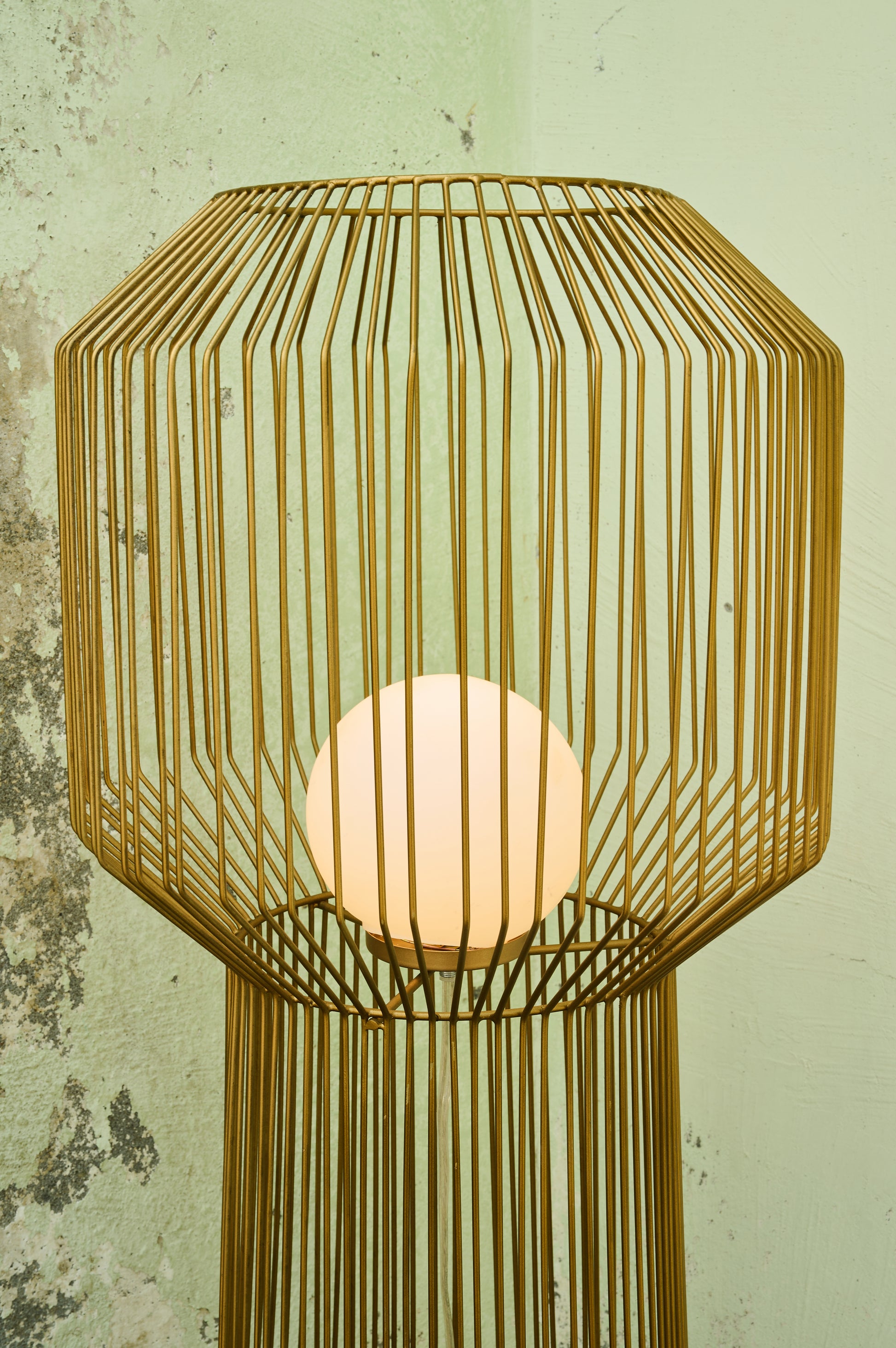 Wooden lamp with geometric design on a textured wall background