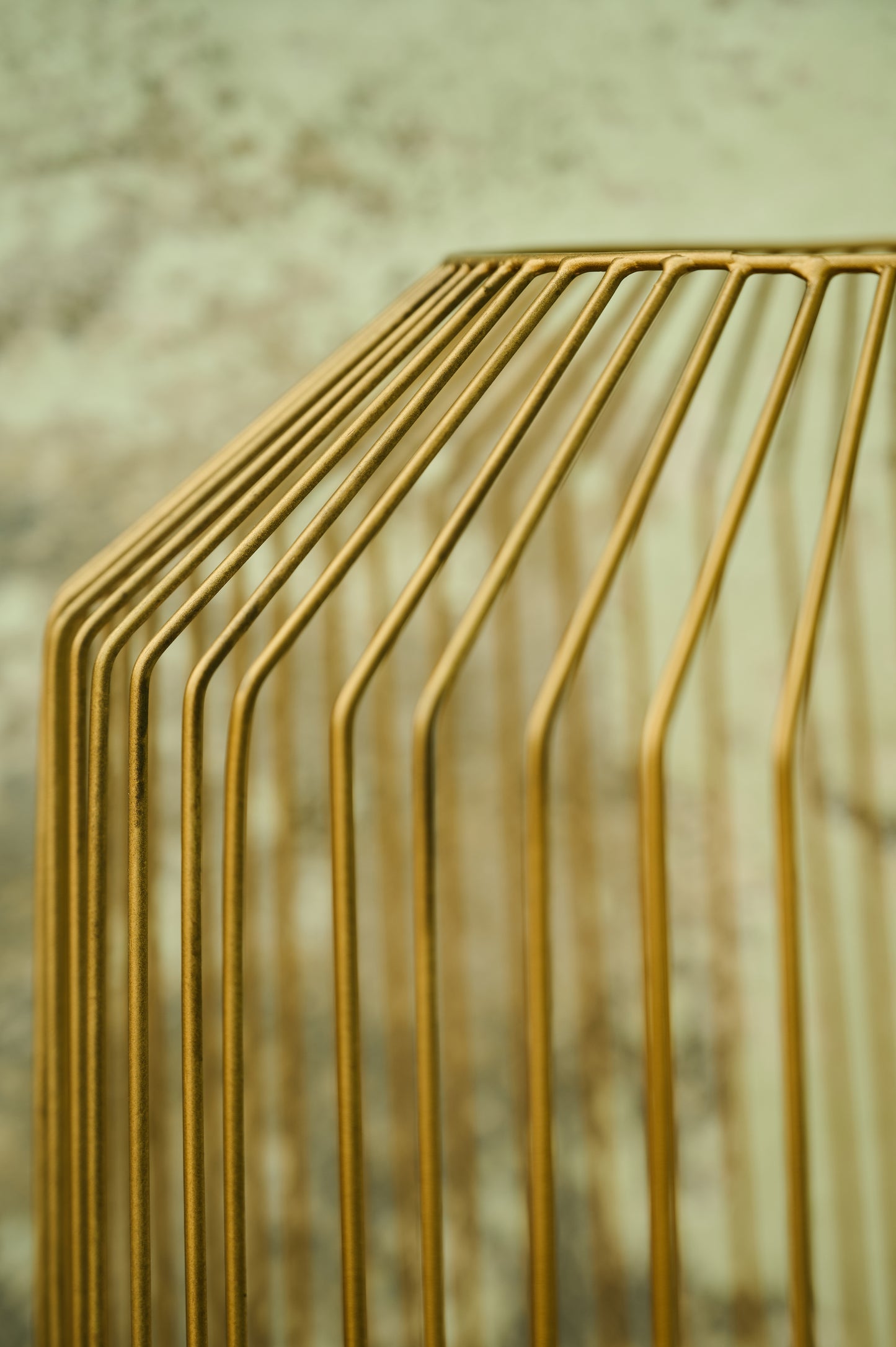 Close-up of a gold metal structure with a blurred background