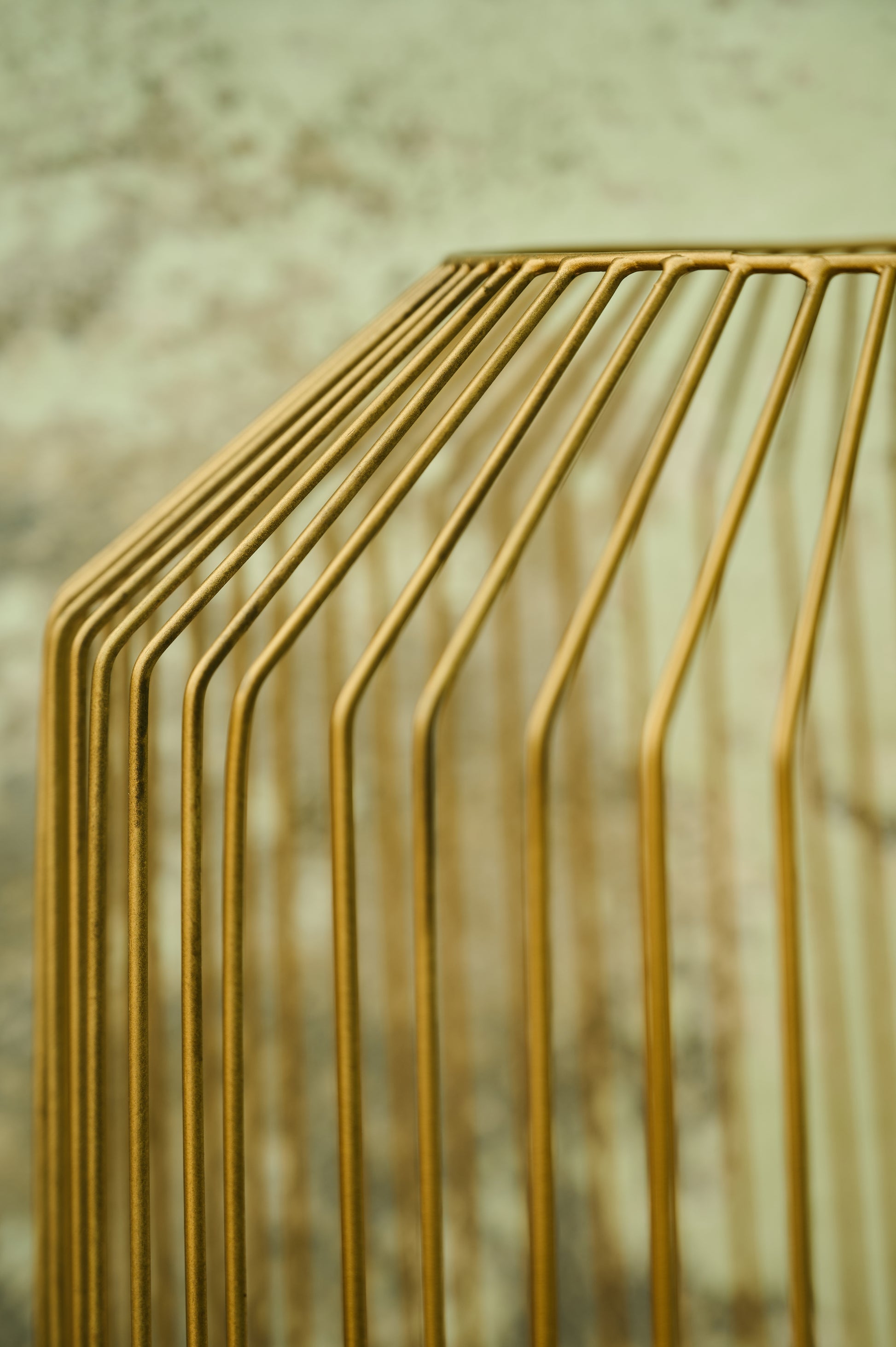 Close-up of a gold metal structure with a blurred background