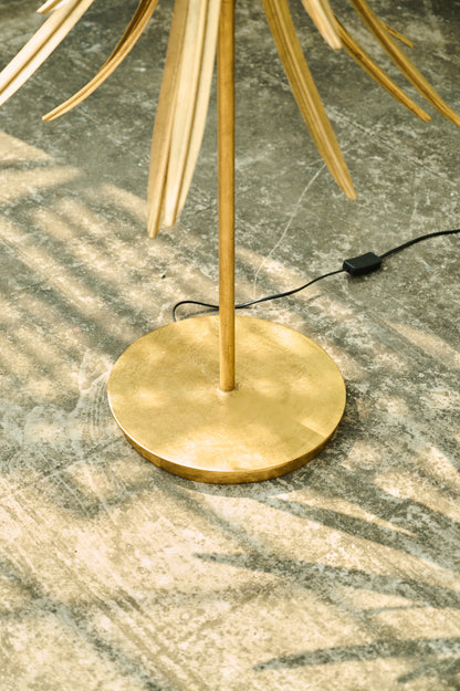 Gold floor lamp on a marble floor