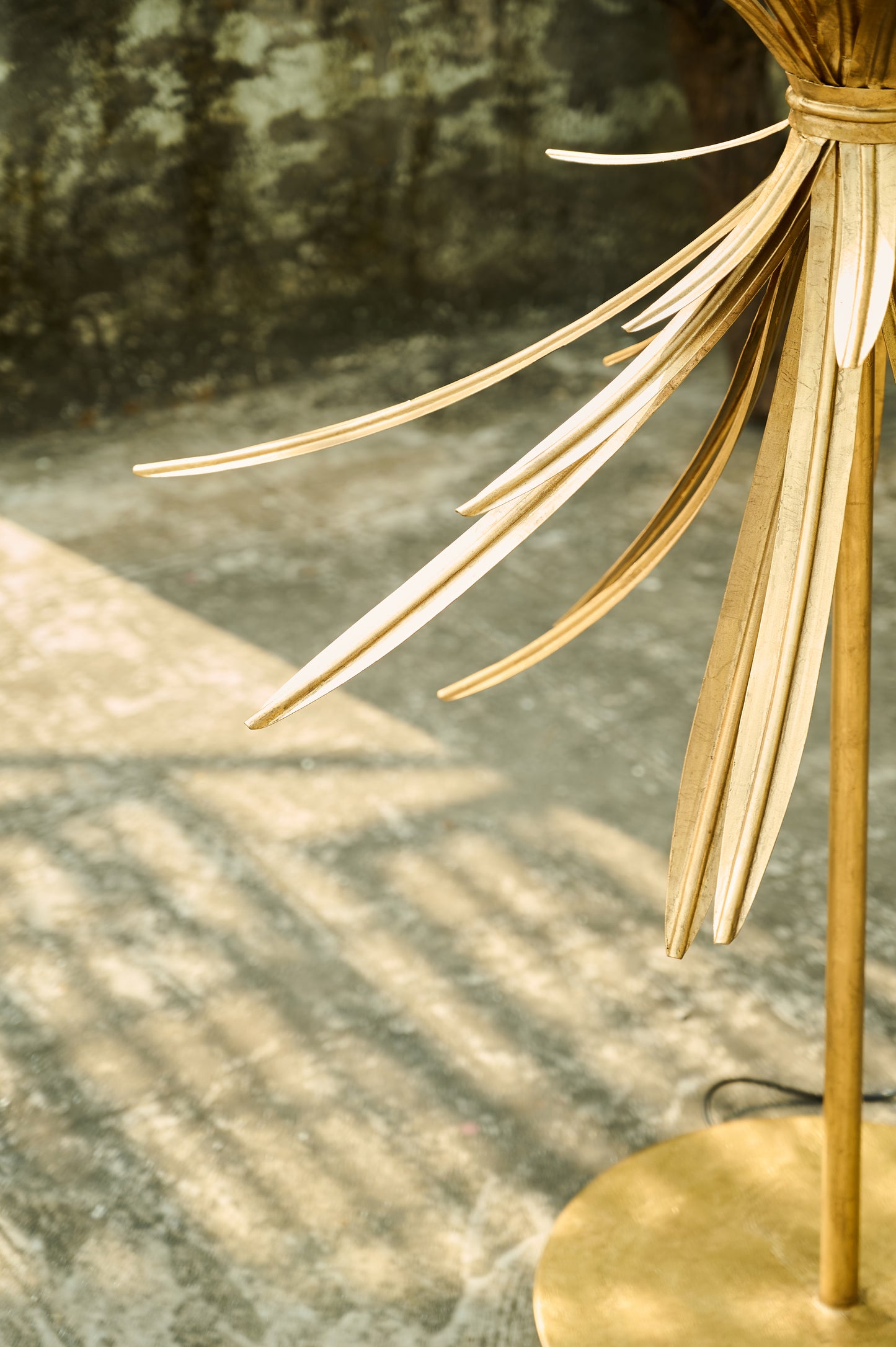 Gold decorative lamp with a textured wall background