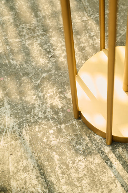 Gold decorative item on a textured surface