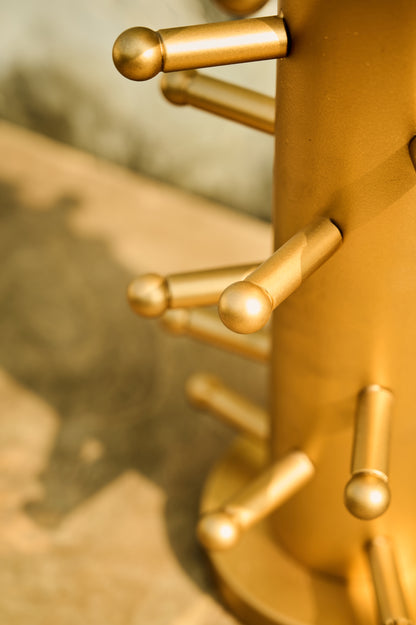Close-up of a gold metal surface with cylindrical protrusions.