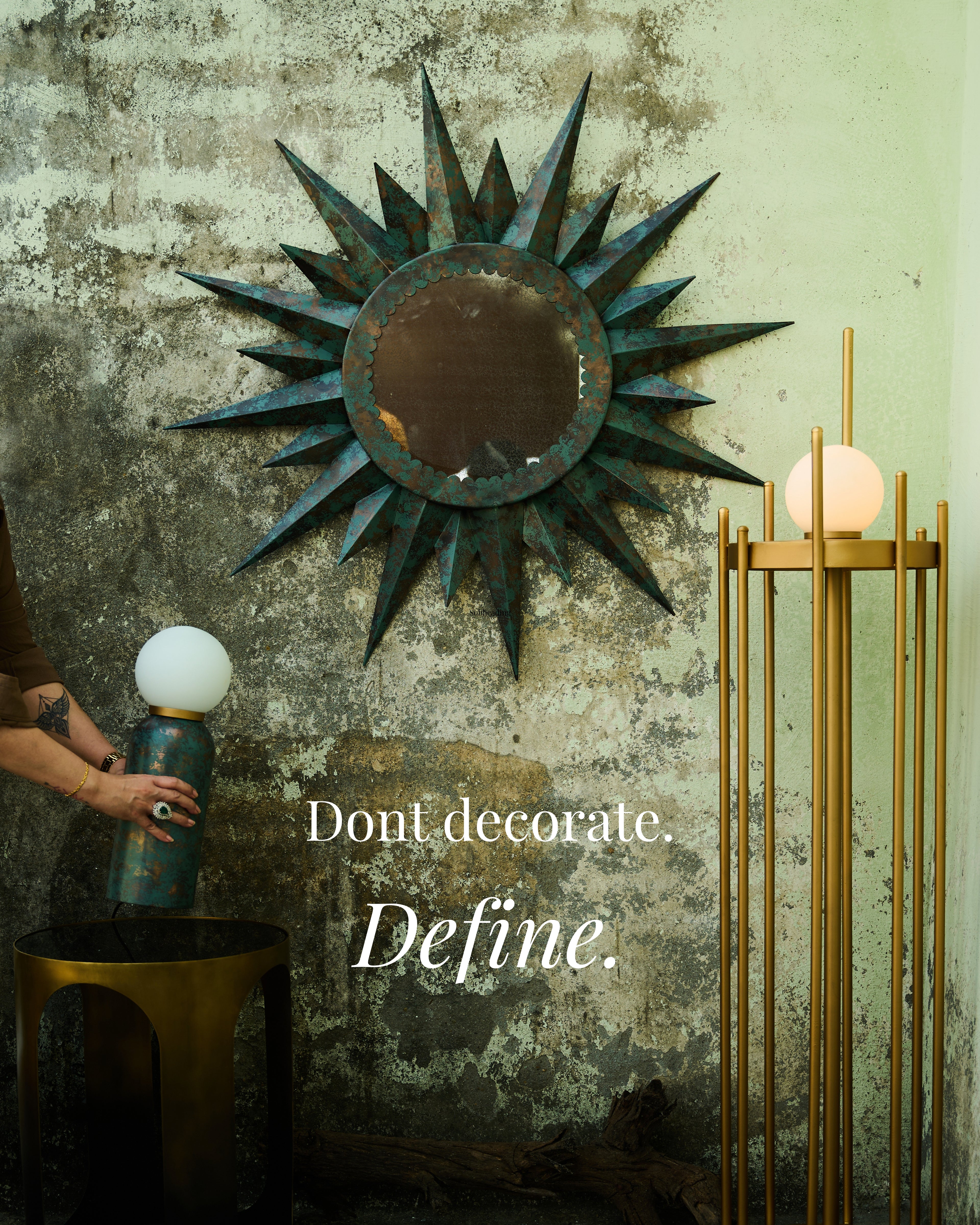 Decorative mirror on a textured wall with a quote 'Don't decorate. Define.'