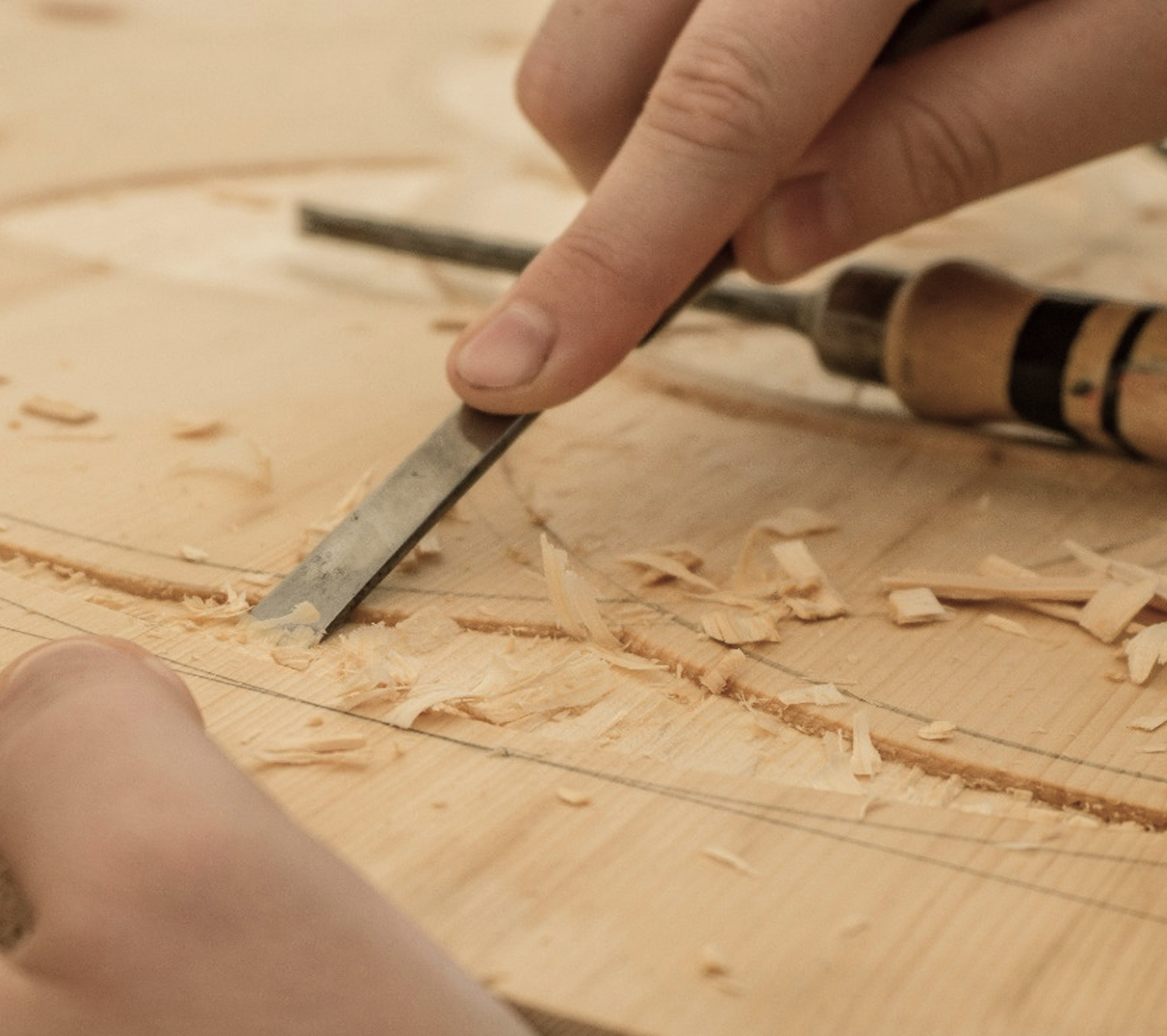 Woodworking tool being used on a wooden surface with wood shavings.